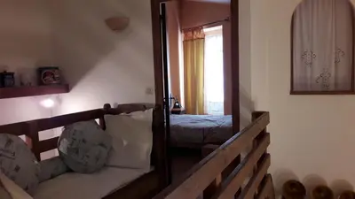 a room with a stairway with a bed and a mirror at La Grange in Durban-Corbières