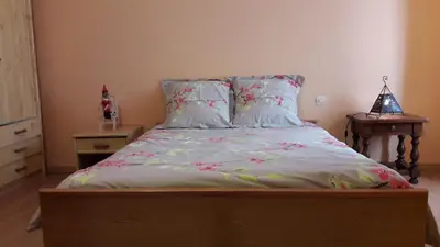 a bedroom with a bed with flowers on it at La Grange in Durban-Corbières
