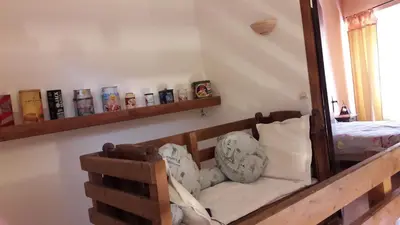 a room with a bench with a mirror and a bed at La Grange in Durban-Corbières