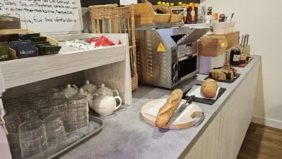 a bakery counter with bread and other items on it at Brit Hotel Plaisance A9/A61 in Narbonne