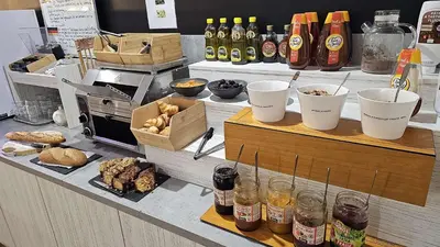 a bakery counter with food and drinks on it at Brit Hotel Plaisance A9/A61 in Narbonne