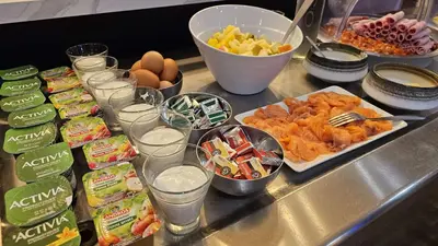 a buffet line with food and drinks and other foods at Brit Hotel Plaisance A9/A61 in Narbonne