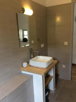 a bathroom with a sink and a mirror at Maison Ancienne Minervois in La Caunette