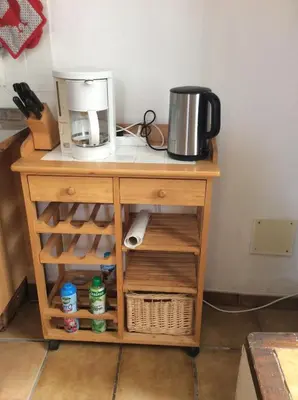 a wooden table with a coffee maker on top of it at Maison Ancienne Minervois in La Caunette