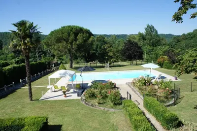 an image of a swimming pool in a garden at La Lauze in Vielmur-sur-Agout