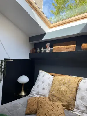 a bedroom with a bed and a blue wall at Le Jardin de LaCoste in Narbonne