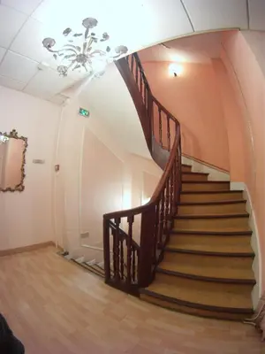 a spiral staircase in a building with a ceiling at Hôtel Le Roi Gourmand in Pamiers