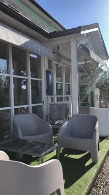 a patio with two chairs and a table and chairs at Le 81 HOTEL in Castres