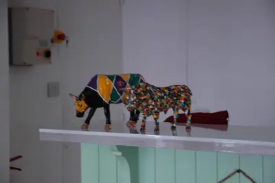 a toy cow on a counter in a room at Le 81 HOTEL in Castres