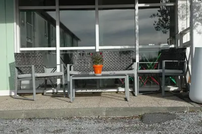 a patio with chairs and a table with a potted plant at Le 81 HOTEL in Castres