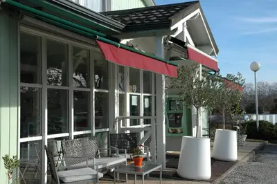 a building with a porch with a red awning at Le 81 HOTEL in Castres