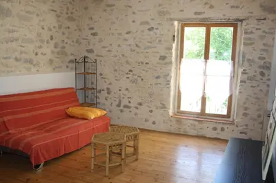 a living room with a couch and a window at Les cèdres in Chalabre