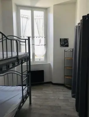 a room with two bunk beds and a window at Les cèdres in Chalabre