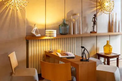 a room with a wooden table and chairs and a desk at Hotel La Chaumière in Quillan