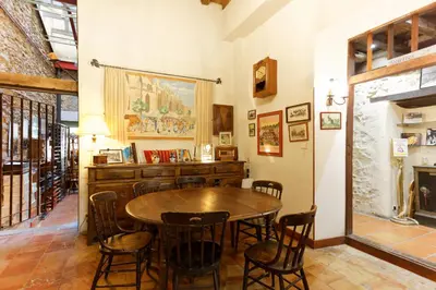 a dining room with a wooden table and chairs at La Maison des Consuls in Mirepoix
