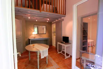 a small room with a table and a desk at Logis auberge restaurant Du Vigneron in Cucugnan