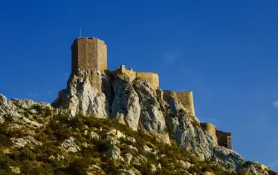 a castle on the top of a mountain at Logis auberge restaurant Du Vigneron in Cucugnan