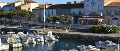 a group of boats docked in a harbor at l'Hotel du port in Port-la-Nouvelle