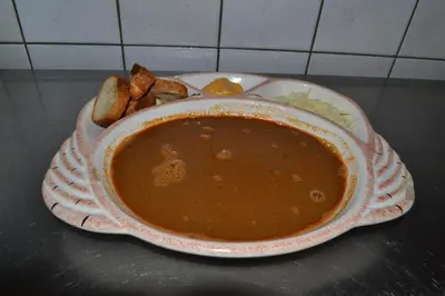 a bowl of soup and a plate of food at l'Hotel du port in Port-la-Nouvelle