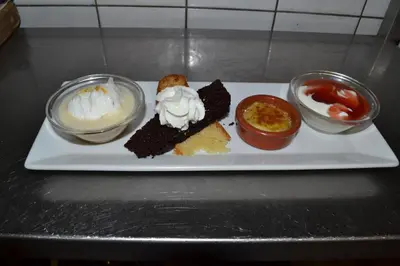 a plate of food with desserts on a table at l'Hotel du port in Port-la-Nouvelle