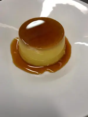 a piece of dessert on a white plate with caramel at Logis Hotels - Hôtel et Restaurant de la Montagne Noire in Dourgne