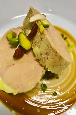 a piece of food on a plate with peanut sauce at Logis Hotels - Hôtel et Restaurant de la Montagne Noire in Dourgne