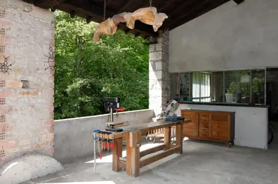 an outdoor kitchen with a wooden table and a sink at Moulin d'entre les roches in Puivert