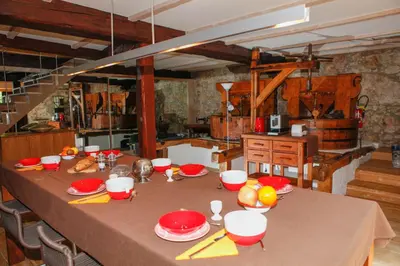 a table with red plates and bowls on top of it at Moulin d'entre les roches in Puivert