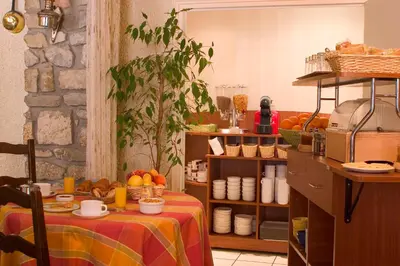 a room with a table with a table cloth on it at Hôtel Le Commerce in Mirepoix