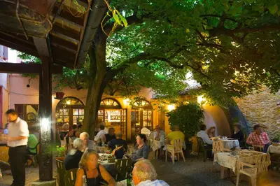 a group of people sitting at tables in a restaurant at Hôtel Le Commerce in Mirepoix