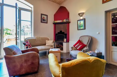 a living room with two couches and a fireplace at Villa Limonade, maison d'hotes in Olonzac