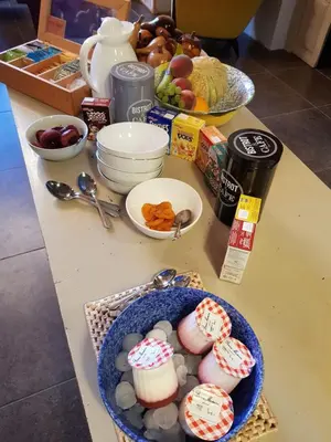 a counter with a table with cookies and other food at Villa Limonade, maison d'hotes in Olonzac