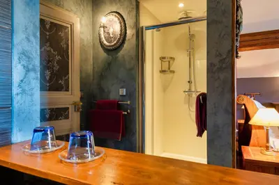 a bathroom with a counter with two glasses on it at Villa Limonade, maison d'hotes in Olonzac