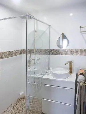 a bathroom with a glass shower and a sink at La Belle Minervoise in Saint-Frichoux