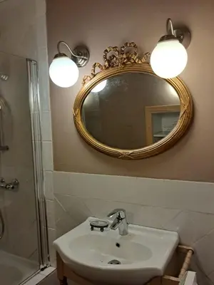 a bathroom with a sink and a mirror at Nabat le Haut, chambre et table d'hotes in Courniou