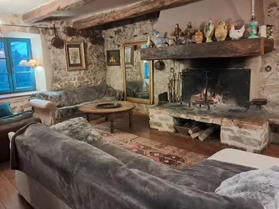a living room with a couch and a fireplace at Nabat le Haut, chambre et table d'hotes in Courniou