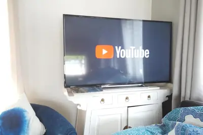 a flat screen tv sitting on a white dresser at Maison de pecheur in Sigean