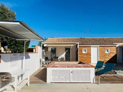 a patio with chairs and a table and a house at Gite Blanco y Madera in Narbonne