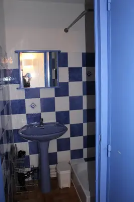 a bathroom with a sink and a toilet and a mirror at Gites de France Bleu à la mer in Port-la-Nouvelle