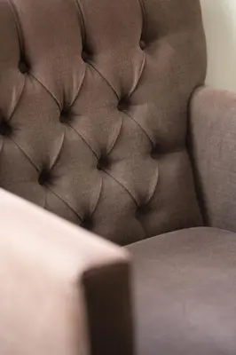 a close up of a brown leather chair at Hotel Restaurant du Centre et du Lauragais in Castelnaudary