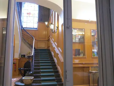 a hallway with a spiral staircase in a building at Hotel Moderne Et Pigeon in Limoux