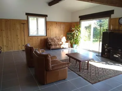 a living room with chairs and a table and a tv at loft At Besset in Besset