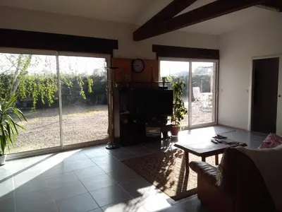 a living room with sliding glass doors and a tv at loft At Besset in Besset