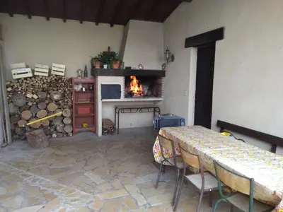 a living room with a fireplace and a table with chairs at loft At Besset in Besset