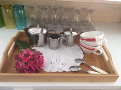 a tray with utensils and cups and flowers on a table at loft At Besset in Besset