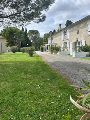 a driveway to a house with a grass yard at Domaine Saladry in Villepinte