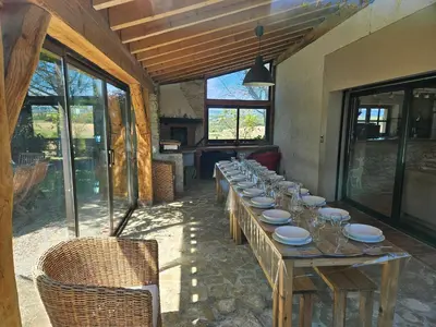 a long wooden table with plates and glasses on it at Domaine Saladry in Villepinte