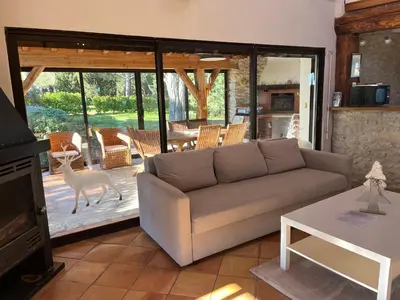 a living room with a couch and a deer on a patio at Domaine Saladry in Villepinte