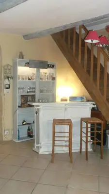 a kitchen with a white counter and a staircase at La Grange d'Antan in Cruzy