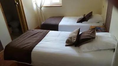 two beds in a hotel room with white sheets at Hotel Ô Fil de L'ô in Marseillette